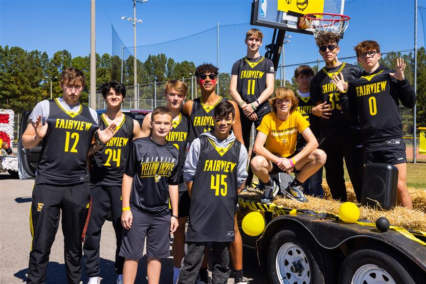 Students ride on a homecoming parade float